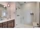 A well lit and modern main bathroom featuring a glass shower and updated lighting fixtures at 11402 Ethereal Landing Ave, Las Vegas, NV 89138