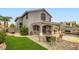Expansive backyard featuring lush green grass, a pool with a waterfall, and multiple seating areas at 1325 Baychester Dr, Henderson, NV 89002