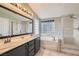 An elegant bathroom features double sinks and a separate tub and shower at 1325 Baychester Dr, Henderson, NV 89002