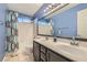 Bathroom featuring a double vanity and a shower-tub combination with blue accent wall at 1325 Baychester Dr, Henderson, NV 89002