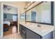 Bright bathroom with double sinks and a view into a bedroom with light blue walls at 1325 Baychester Dr, Henderson, NV 89002