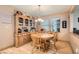 Charming dining room featuring a wooden table and chairs, complemented by a stylish hutch at 1325 Baychester Dr, Henderson, NV 89002