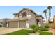 Beautiful two-story home with a well-maintained lawn and a spacious three-car garage at 1325 Baychester Dr, Henderson, NV 89002