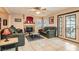 Cozy living room with a fireplace and a view of the backyard at 1325 Baychester Dr, Henderson, NV 89002