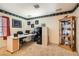 Well-lit home office featuring a sleek white desk, ample storage, and stylish decor for a productive workspace at 1325 Baychester Dr, Henderson, NV 89002