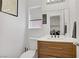 Half-bath with wood vanity, modern fixtures, and access to laundry room at 1428 Daybreak Dr, Las Vegas, NV 89108