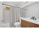 Updated bathroom features a modern vanity and a shower-tub combination with stylish fixtures at 1428 Daybreak Dr, Las Vegas, NV 89108