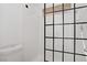 Modern bathroom showcasing a tiled shower with a black-framed glass enclosure at 1428 Daybreak Dr, Las Vegas, NV 89108