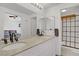 Bright bathroom featuring a granite-topped double vanity and a stylish glass-enclosed shower at 1428 Daybreak Dr, Las Vegas, NV 89108