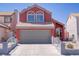 Charming coral two-story home featuring an attached two-car garage and easy-to-maintain landscaping at 1428 Daybreak Dr, Las Vegas, NV 89108