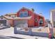 Charming coral two-story home featuring an attached two-car garage and low-maintenance desert landscaping at 1428 Daybreak Dr, Las Vegas, NV 89108