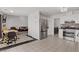 Spacious kitchen featuring stainless steel appliances, white cabinetry, and a dining area adjacent to the living room at 1428 Daybreak Dr, Las Vegas, NV 89108