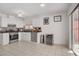 Well-equipped kitchen featuring stainless steel appliances, white cabinetry, and a stylish backsplash at 1428 Daybreak Dr, Las Vegas, NV 89108