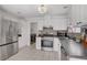 Bright kitchen features stainless steel appliances, modern backsplash, and access to laundry room at 1428 Daybreak Dr, Las Vegas, NV 89108