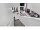View of living room from top of stairs featuring black and white tile floors and cozy fireplace at 1428 Daybreak Dr, Las Vegas, NV 89108