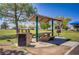 Covered picnic area with bench seating and a grill in a beautiful park at 1428 Daybreak Dr, Las Vegas, NV 89108