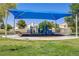 Covered playground with slides and climbing equipment surrounded by grass and trees at 1428 Daybreak Dr, Las Vegas, NV 89108