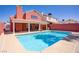 A refreshing pool provides a welcome escape in the backyard of this inviting coral-colored home at 1428 Daybreak Dr, Las Vegas, NV 89108