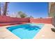 Relax in this private pool with a built in bench and a perfectly sunny sky at 1428 Daybreak Dr, Las Vegas, NV 89108