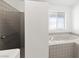 Cozy bathroom featuring a walk-in shower and a bathtub under the window at 170 Dove St, Pahrump, NV 89060