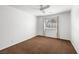 Simple bedroom with neutral walls, carpet, and a ceiling fan and window for natural light at 170 Dove St, Pahrump, NV 89060