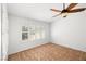 Bright bedroom featuring tile flooring, a window with shutters, and a ceiling fan at 170 Dove St, Pahrump, NV 89060