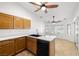 Functional kitchen featuring wood cabinetry, a black dishwasher, and solid surface countertops at 170 Dove St, Pahrump, NV 89060