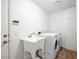 Clean laundry room equipped with a utility sink and modern washer and dryer at 170 Dove St, Pahrump, NV 89060