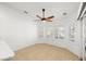 Bright living room with a ceiling fan and natural light pouring in from large windows at 170 Dove St, Pahrump, NV 89060