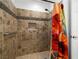 Shower with a handrail and decorative tile work at 170 Dove St, Pahrump, NV 89060