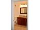 Bathroom vanity with wood cabinetry, granite countertop, and tile flooring at 1830 N Buffalo Dr # 1010, Las Vegas, NV 89128