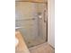 Tiled shower with glass door, grab bar, and hand-held showerhead at 1830 N Buffalo Dr # 1010, Las Vegas, NV 89128