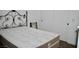 This bedroom features a bed with a decorative headboard and closet at 1830 N Buffalo Dr # 1010, Las Vegas, NV 89128