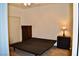 Bedroom with carpet and empty bed frame with closet doors and dresser at 1830 N Buffalo Dr # 1010, Las Vegas, NV 89128