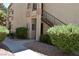 Charming exterior view of the townhome with private entrance and stairs to upper units at 1830 N Buffalo Dr # 1010, Las Vegas, NV 89128