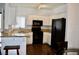 Bright kitchen features white cabinets, granite countertops, and black appliances at 1830 N Buffalo Dr # 1010, Las Vegas, NV 89128