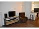 Comfortable living room featuring hardwood floors, tv and bar stool kitchen access at 1830 N Buffalo Dr # 1010, Las Vegas, NV 89128