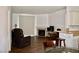 Open-concept living room and kitchen view with fireplace, bar stool kitchen access and hardwood floors at 1830 N Buffalo Dr # 1010, Las Vegas, NV 89128