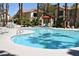 Sparkling community pool with lounge chairs and shaded seating area, ideal for summer relaxation at 1830 N Buffalo Dr # 1010, Las Vegas, NV 89128