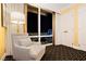 Cozy bedroom chair placed near large windows with city views at night and curtains at 2000 Fashion Show Dr # 5022, Las Vegas, NV 89109