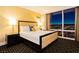 Bedroom featuring a king bed, large windows with a city view at night, and a nightstand with a lamp at 2000 Fashion Show Dr # 5022, Las Vegas, NV 89109