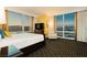 Beautiful bedroom with a king bed, chair, and floor-to-ceiling windows overlooking the city at 2000 Fashion Show Dr # 5022, Las Vegas, NV 89109