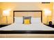 Close-up of king bed with a tufted headboard, white linens, and matching nightstands with lamps at 2000 Fashion Show Dr # 5022, Las Vegas, NV 89109