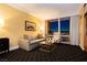 Bright living room features a sofa, chair, coffee table, and large windows with an incredible city view at night at 2000 Fashion Show Dr # 5022, Las Vegas, NV 89109