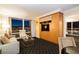 Comfortable living room features a sofa, chair, built-in shelves, large windows with city views at night, and geometric flooring at 2000 Fashion Show Dr # 5022, Las Vegas, NV 89109