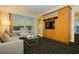 Comfortable suite living room featuring a city view, sofa, armchair, and built-in entertainment center at 2000 Fashion Show Dr # 5022, Las Vegas, NV 89109