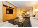 Open-concept suite living space with a comfy sofa, open floorplan, and a built in entertainment center at 2000 Fashion Show Dr # 5022, Las Vegas, NV 89109