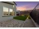 A paver patio and artificial turf area compliment the rear exterior of this home at 2004 Peaceful Mesa Ct, Henderson, NV 89052