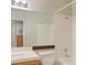 A bathroom with tile countertop, a mirror, tub and shower combination, and neutral wall color at 2132 Chertsey Dr # B, Las Vegas, NV 89108
