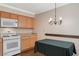 Dining area with wood floors, overhead lighting and light wood cabinets at 2132 Chertsey Dr # B, Las Vegas, NV 89108